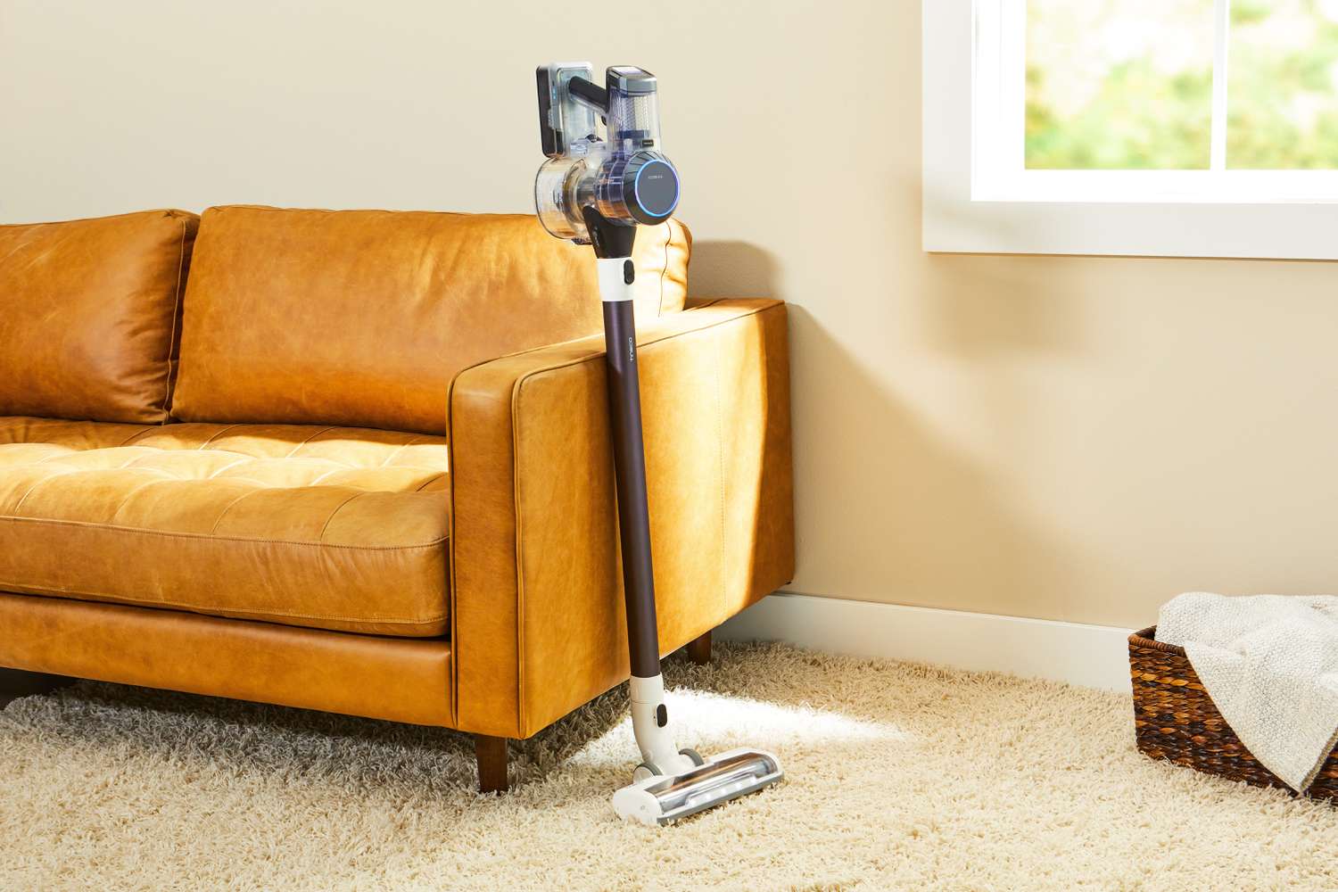 Tineco Pure One S11 Smart Stick/Handheld Vacuum displayed against a leather sofa