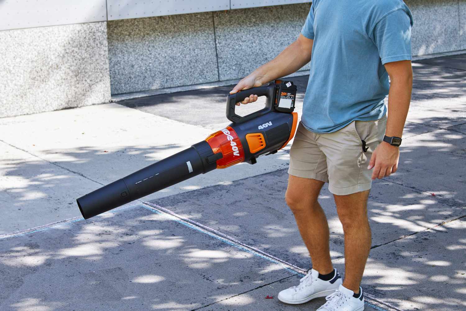 Person using a WORX 40V Turbine Cordless Leaf Blower Power Share with Brushless Motor to blow off concrete walkway