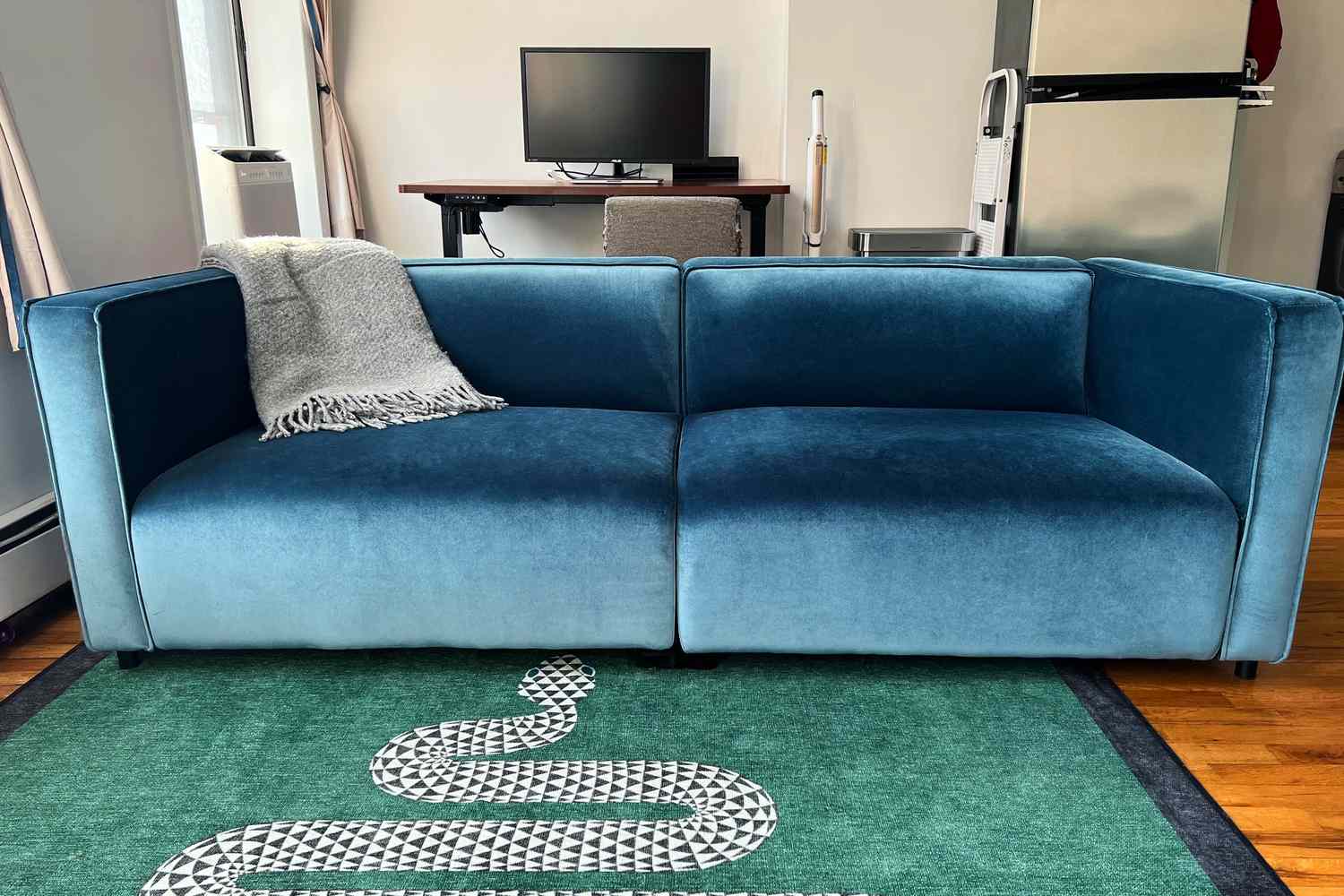 A dark blue velvet couch from Rove Concepts