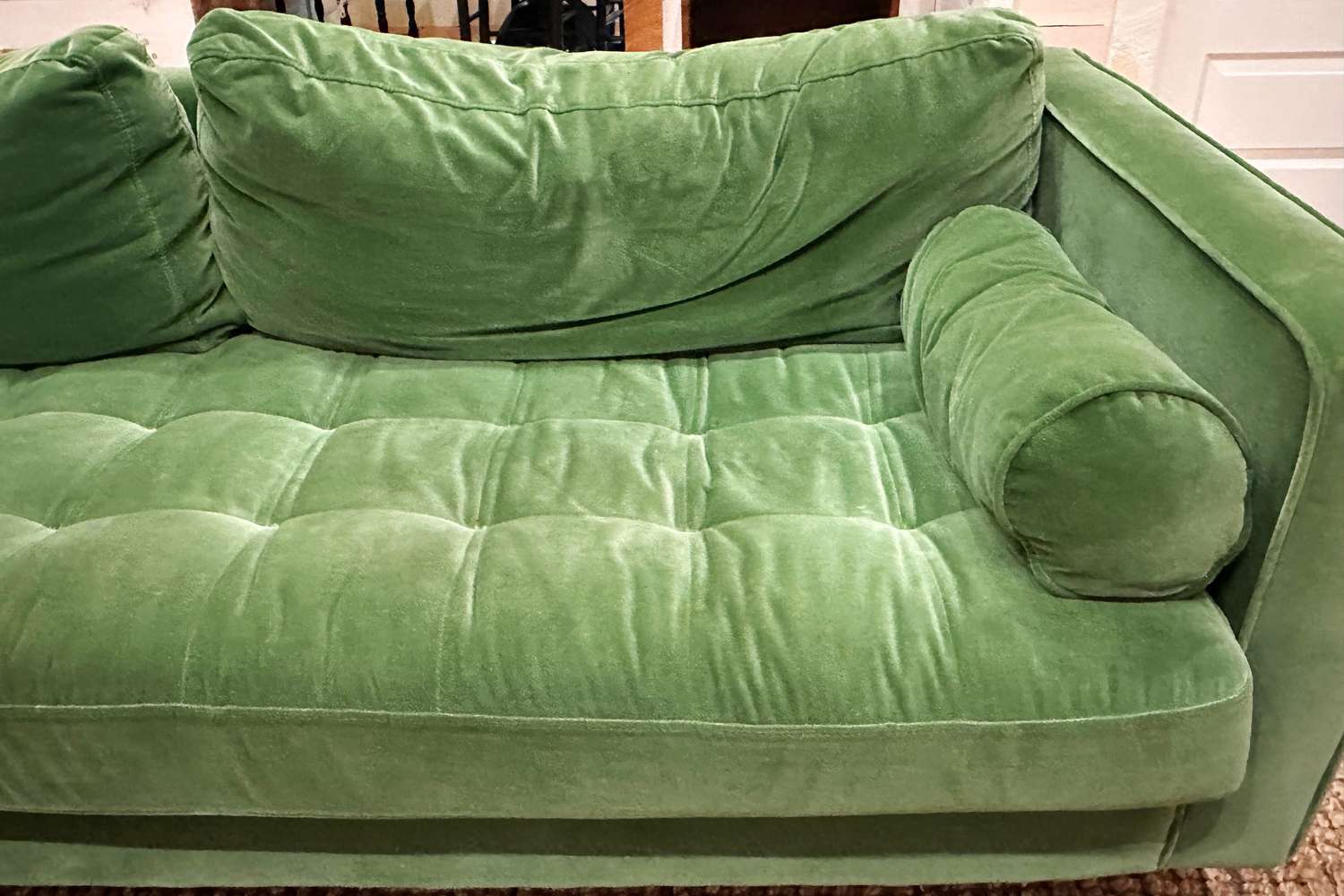 A close up of the green Article Sven Sofa