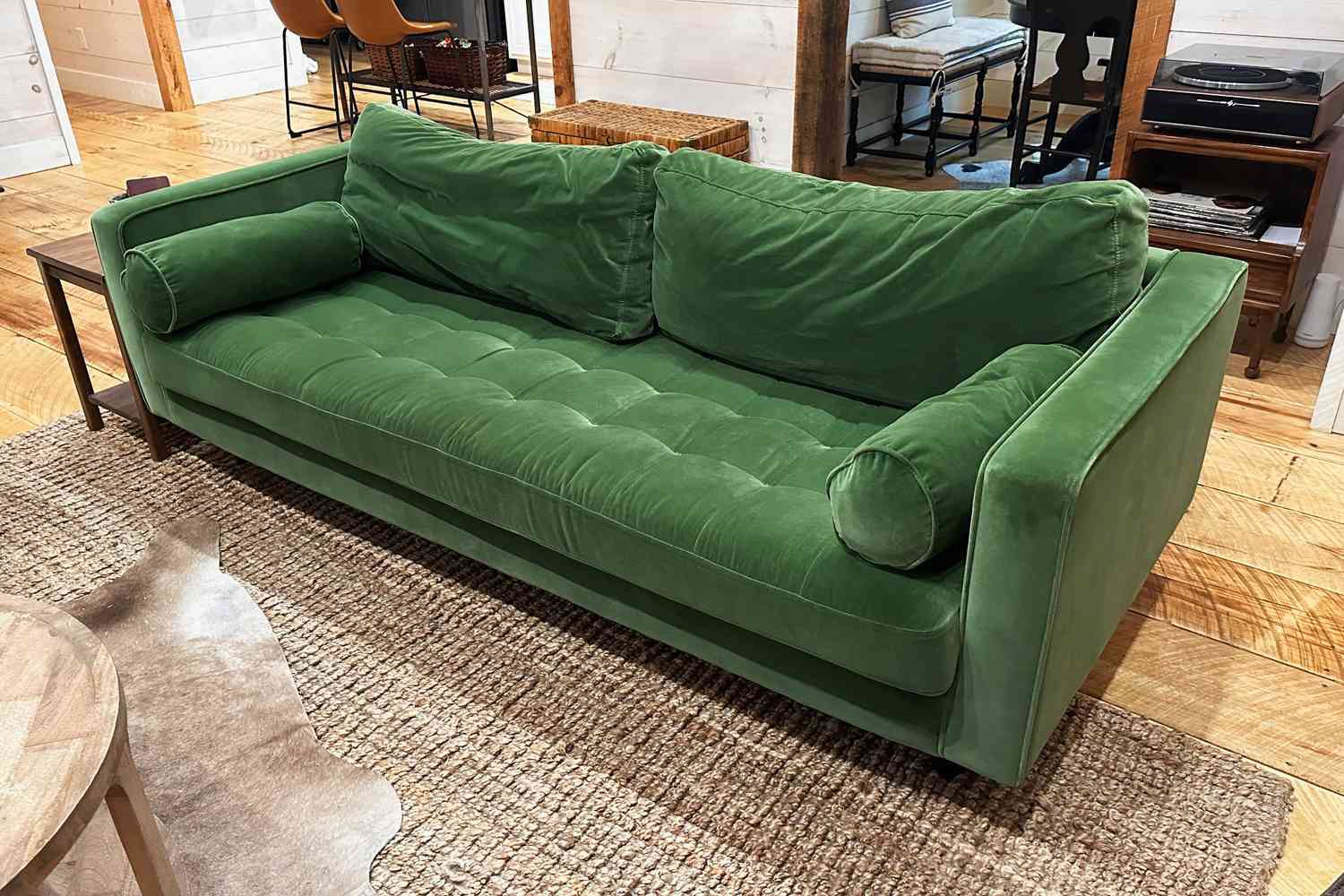 A green Article Sven Sofa set up in a living room